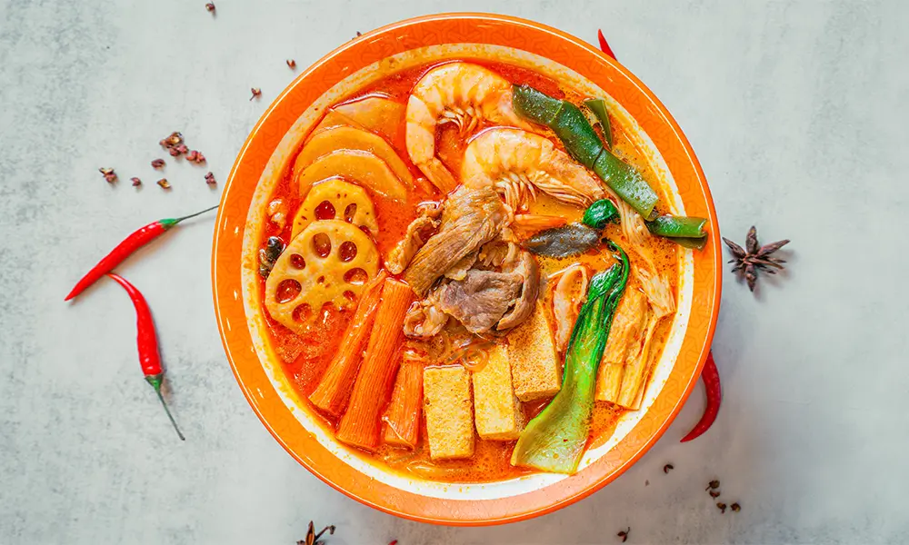 Spicy malatang with shrimp, beef, lotus root, tofu, and greens in herbal beef bone broth at YGF Malatang-Katy, a Chinese Restaurant in Katy