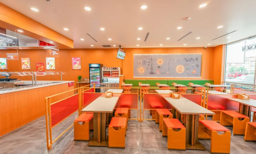 Spacious restaurant with mixed seating, decorative walls, and a bright atmosphere at YGF Malatang-Katy, a Chinese Restaurant in Katy